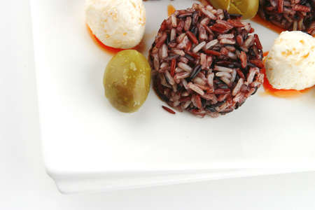 mozarella cheese and dark rice served on plateの写真素材