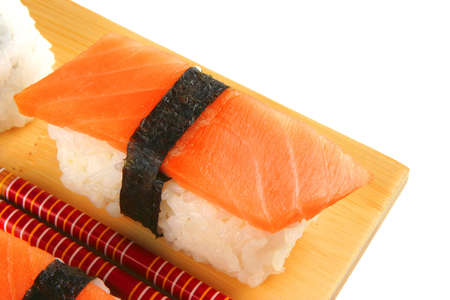 mixed plate of sushi on plate over whiteの写真素材