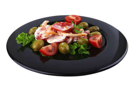 tomatoes salad and olives on black dishの写真素材