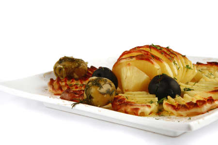 fried potatoes and olives over white backgroundの写真素材