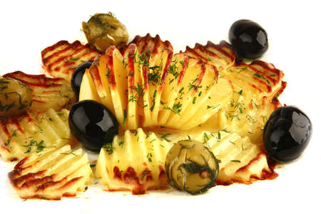 golden fried potatoes on white with olivesの写真素材