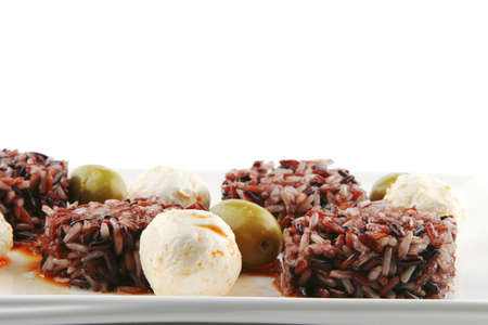 mozarella cheese and dark rice served on plateの写真素材