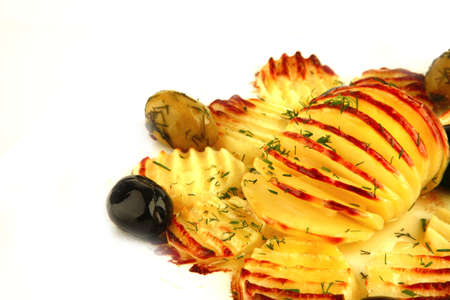 fried potatoes with olives on white dishの写真素材