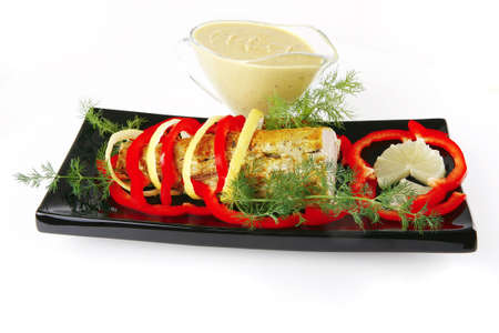 roast tuna fillet served on black plate with sauceの写真素材