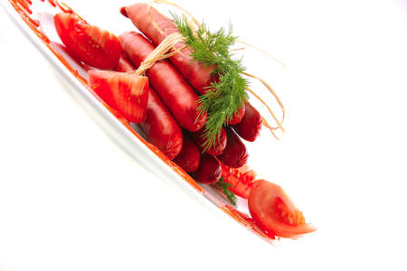 smoked beef sausages served on a white plateの写真素材