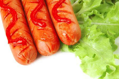 sausages served with ketchup salad and tomato の写真素材