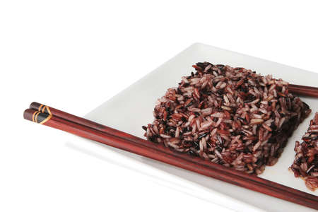 boiled dark mixed rice on white plateの写真素材