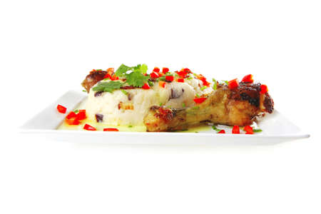 chicken legs served with vegetables on porcelain plateの写真素材