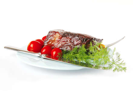 meat chunk on blue dish with knife and forkの写真素材