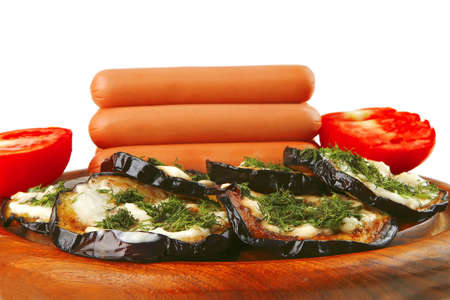 sausages served on wooden plate with grilled eggplantの写真素材