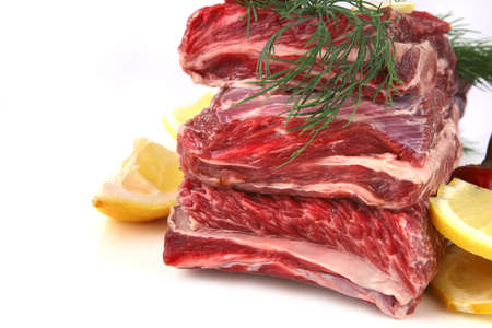 beef uncooked rib's close up over whiteの写真素材