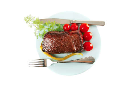 served beef meat chunk and tomatoes on blueの写真素材