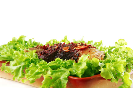 roast steak served on green salad on bowl