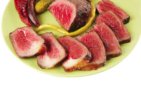 meat slices and chunk with vegetables and peppersの写真素材