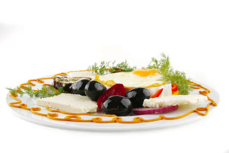 fried egg served on white plate with vegetablesの写真素材