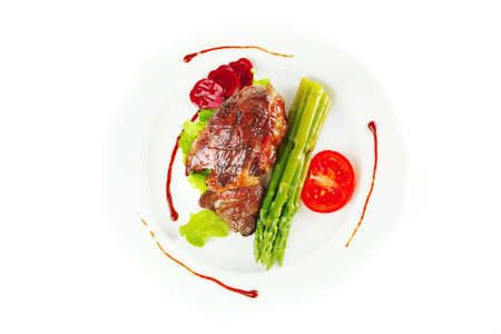 roasted beef meat served with asparagus on plateの写真素材