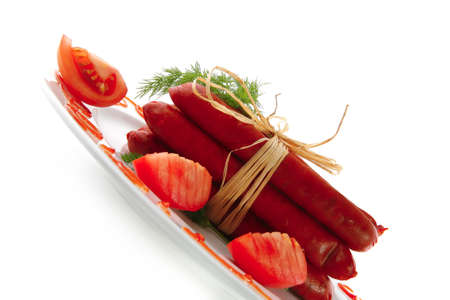 fresh pork smoked sausages on a white dish の写真素材