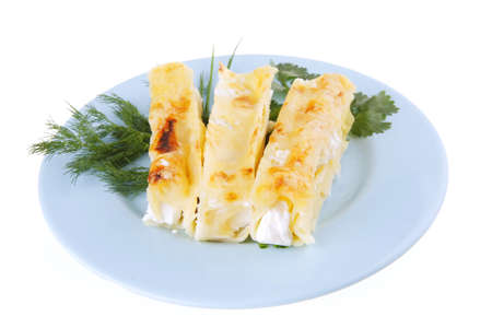 cannelloni in yellow cheese served with greeneryの写真素材