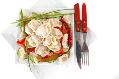 meat dumplings served on white plate with vegetablesの写真素材