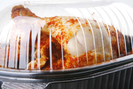 isolated roast chicken for take away over whiteの写真素材