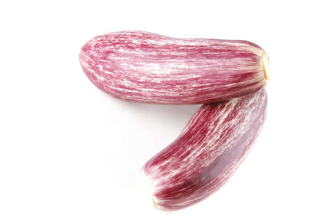 raw uncooked small violet eggplants over whiteの写真素材