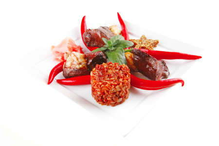 meat main course served on white plate over whiteの写真素材