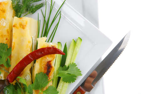 baked cannelloni with cheese served with greenery on dish