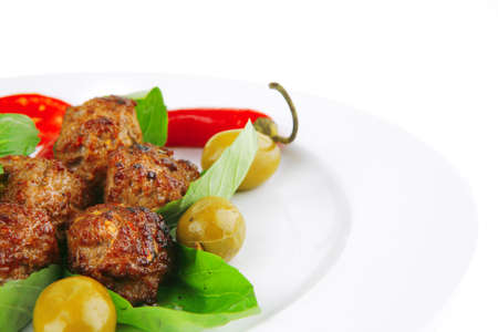 roasted cutlets served on basil with vegetablesの写真素材