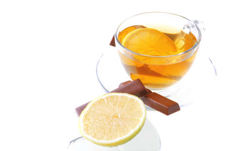 dark chocolate and tea with lemon on whiteの写真素材