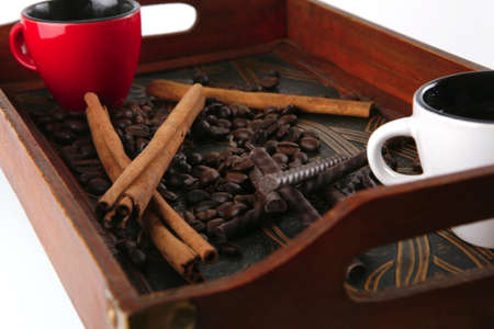 coffee served with chocolate and cinnamon sticksの写真素材