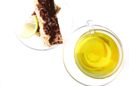 black tea and lemon cake on white backgroundの写真素材