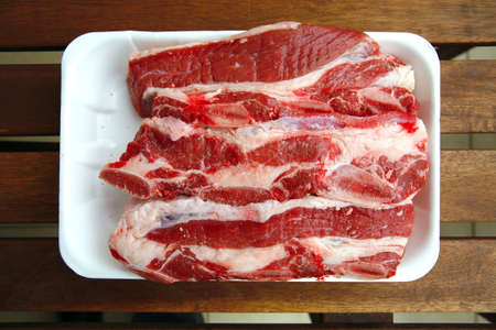 image of raw ribs on wooden tableの写真素材