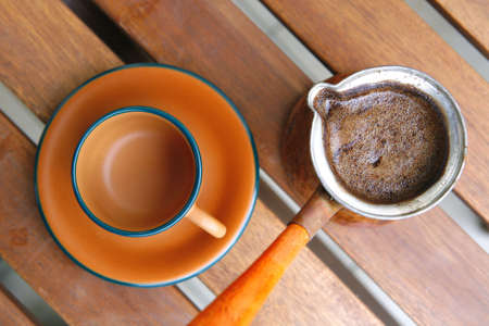 image of black coffee cup on wooden tableの写真素材