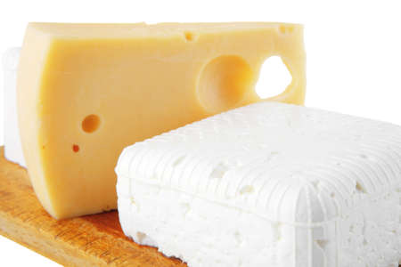 french and greek cheeses on wooden boardの写真素材