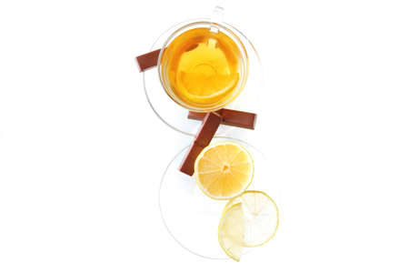 lemon and tea with chocolate on transparent dishwareの写真素材