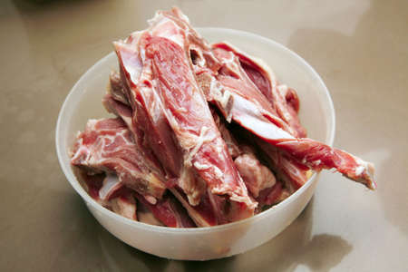 cutted lamb ribs in plastic bowl on marbleの写真素材