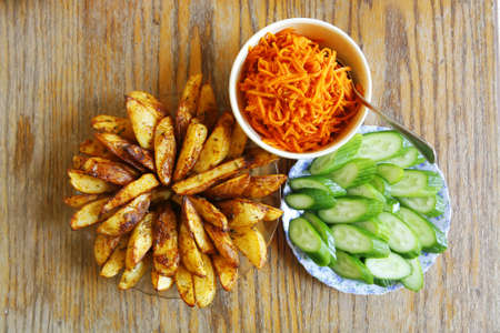 fresh vegetable salad served on wooden tableの写真素材