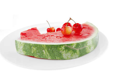 fresh raw watermelon and cherry on white plateの写真素材