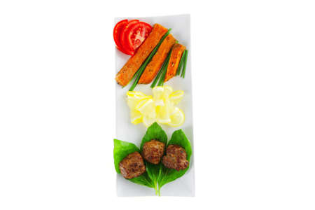 roast meatballs on basil over white plateの写真素材