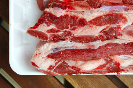 image of raw ribs on wooden tableの写真素材