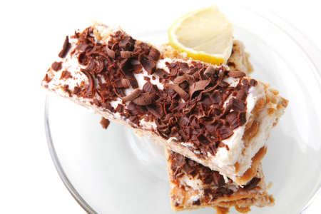 little cakes with lemon slice on transparent saucerの写真素材