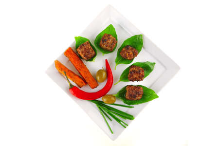 grilled french cutlets served on basil leafsの写真素材