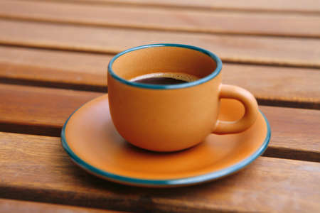 image of black coffee cup on wooden tableの写真素材