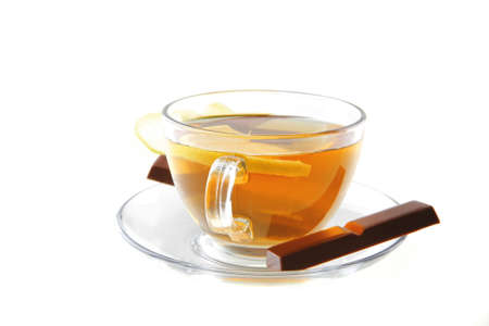 lemon and tea with chocolate on transparent dishwareの写真素材