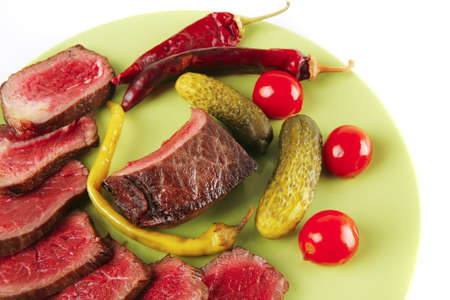 meat and vegetables with peppers on greenの写真素材