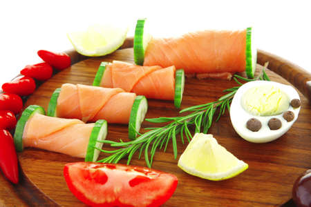 image of smoked salmon rolls on wooden plateの写真素材