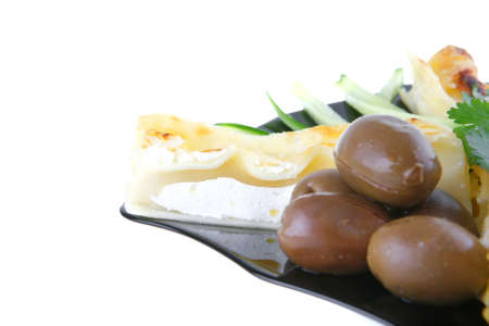 cannelloni in yellow cheese served with pepper and olivesの写真素材