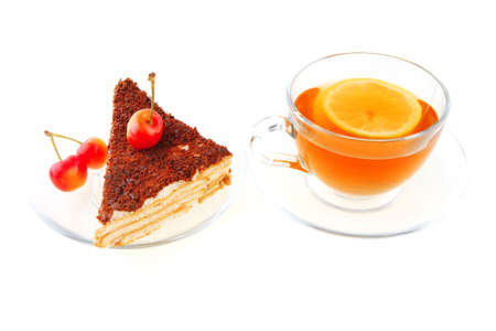 golden tea, chocolate cake and cherry on whiteの写真素材