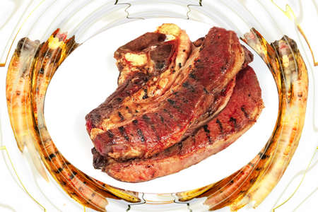 cooked meat on white dish over white backgroundの写真素材