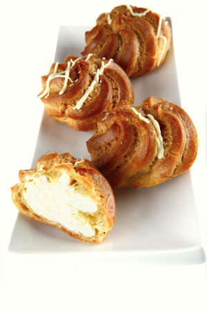 yummy creamy cakes served over white background